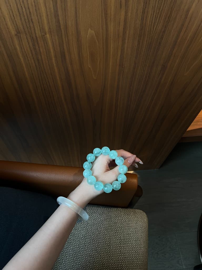 Aqua quartz bracelet held in hand
