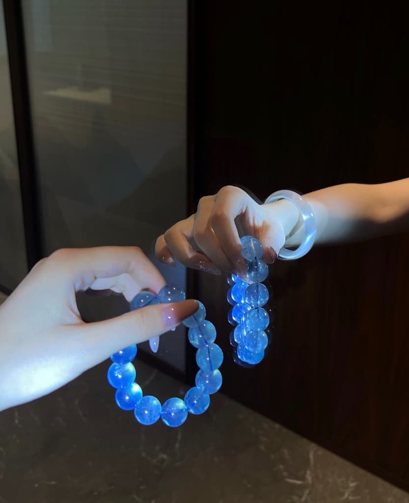 Devil blue aquamarine bracelet held between two hands