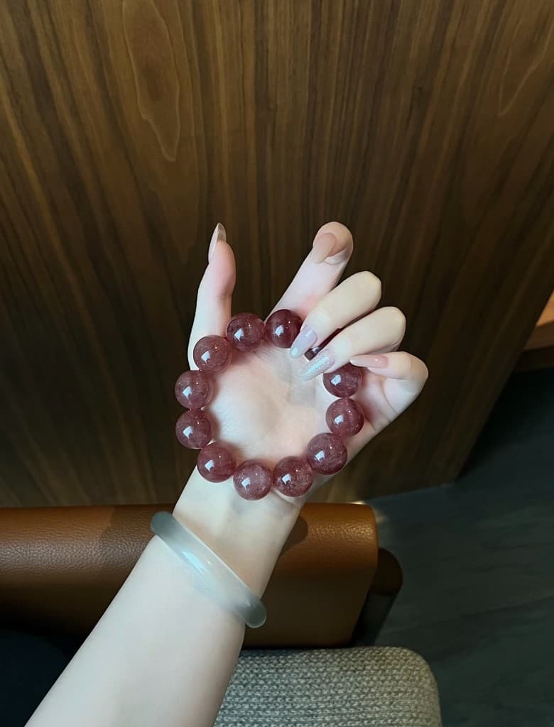 Strawberry quartz bracelet worn on the wrist