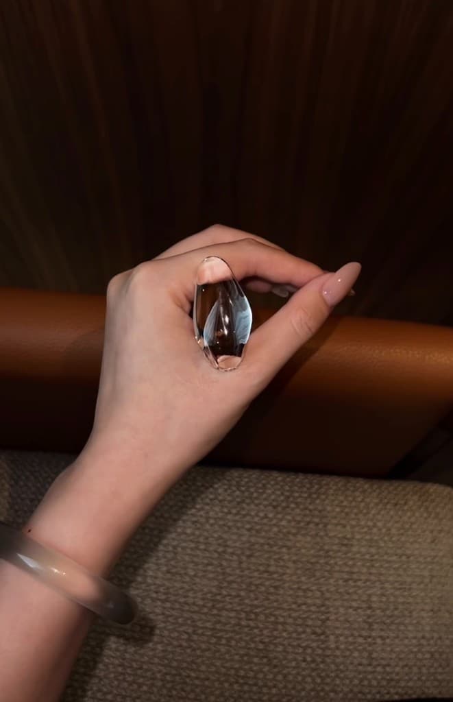 Blue needle quartz palm stone held in hand